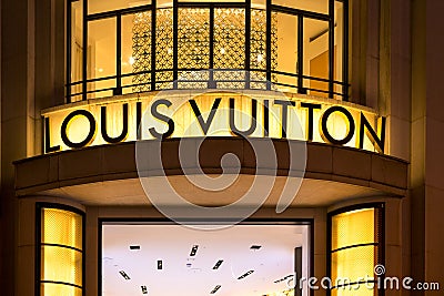 Louis Vuitton, illuminated jewelry and high couture brand name on Champs Elysees avenue in Paris Editorial Stock Photo