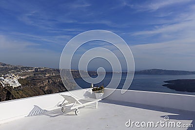 Lounge chair over Santorini caldera, Greece Stock Photo