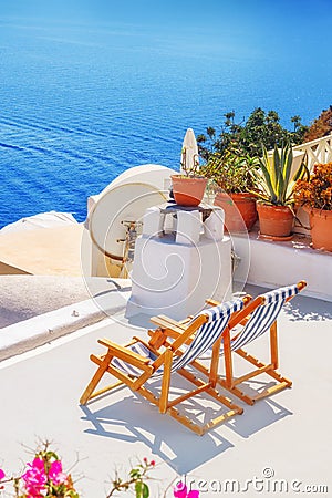 Lounge chairs with a view of the caldera, Oia village, Santorini Stock Photo