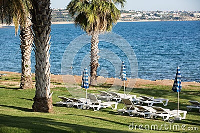 Lounges and umbrellas on sea beach Stock Photo