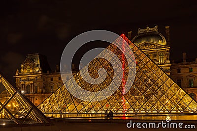 Louvre Museum and the Pyramid in Paris, France, at night illumi Editorial Stock Photo