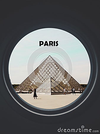 Louvre museum seen through a circular window labeled Paris Editorial Stock Photo
