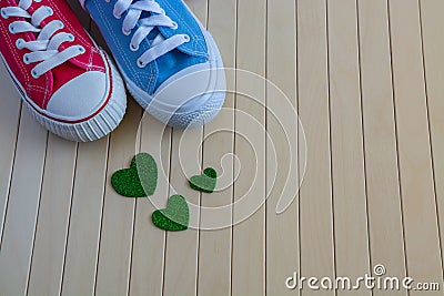 Love background with different sneakers and green hearts Stock Photo