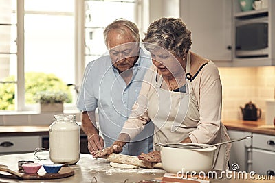 We love baking together. a senior couple baking together at home. Stock Photo