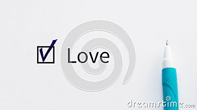 Love - checkbox with a tick on white paper with blue pen. Checklist concept. Stock Photo