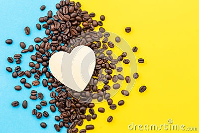 Love coffee concept, Top view white heart on the coffee grain on yellow Stock Photo