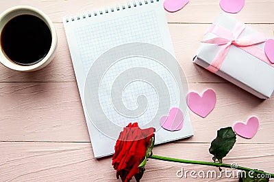 Love composition - coffee cup, gift box and red rose on pink background, top view. Stock Photo