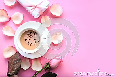 Love composition - coffee cup, rose and gift box on pink background. Stock Photo