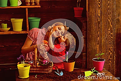 Love concept. Little child kiss mother planting flowers with love. Grown with love. Love and protect nature Stock Photo
