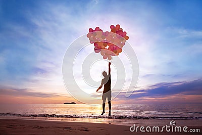 Love concept, man flying with heart from balloons Stock Photo