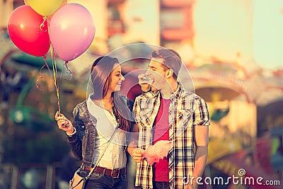 Love couple in amusement park with cotton candy Stock Photo