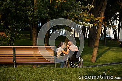 Love couple, care for disabled man in wheelchair Stock Photo