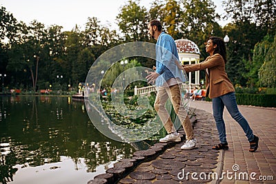 Love couple having fun at the pond in summer park Stock Photo