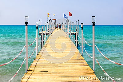 Love couple walks on the pier, leaving in the sea. Editorial Stock Photo