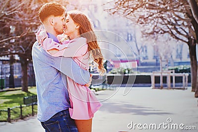 Love and dating, young beautiful couple kissing and laughing outdoors Stock Photo