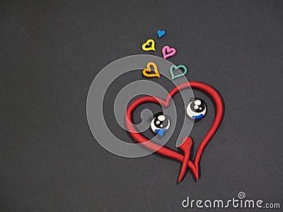 Love does not love. Tears of happiness. Plasticine heart Stock Photo