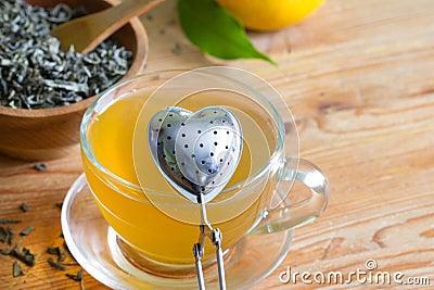 Love drinking tea with infuser heart valentines abstract concept on wooden background Stock Photo
