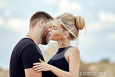 In love Eastern couple in mountains of Cappadocia hugs and kisses. Love and emotions loving couple vacationing in Turkey. Closeup Stock Photo