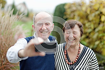 Love in focus. Happy senior couple bonding to each other and making selfie Stock Photo