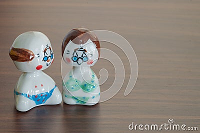 Love Grandfather and grandmother ceramic dolls on wooden table b Stock Photo