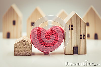 Love heart between big and small house model for stay at home love together and healthy community concept Stock Photo