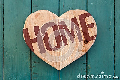 Love home message wooden heart on turquoise painted background Stock Photo