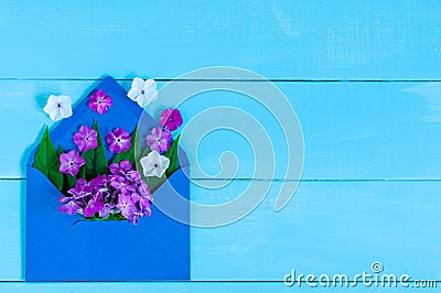 Love - letter with flower, romantic message on blue wooden background. Valentines day cards empty space for text Stock Photo