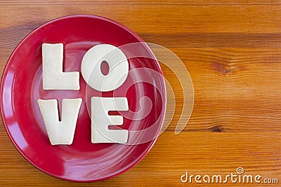 Love letters cookies on red plate. Stock Photo