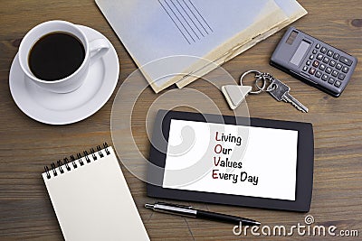LOVE - Living our values every day. Text on tablet device on a w Stock Photo