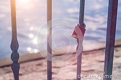 Love lock or love padlock in front of a lake with sun reflection flares Stock Photo