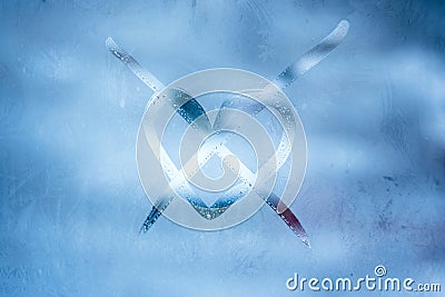 Love loneliness winter concept. Crossed heart handwritten symbol on the glass window with frozen patterns Stock Photo