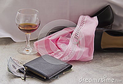 Love for money is prostitution. Crumpled bed, underwear and money as payment for sex. Panties are on women`s shoes Stock Photo