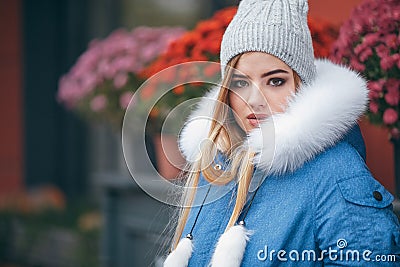 In love with nature, a girl in a jacket walks through the autumn park. warm clothes for the autumn season Stock Photo