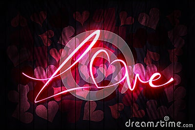 Love Neon Sign on a Dark Wooden Wall with hearts Stock Photo