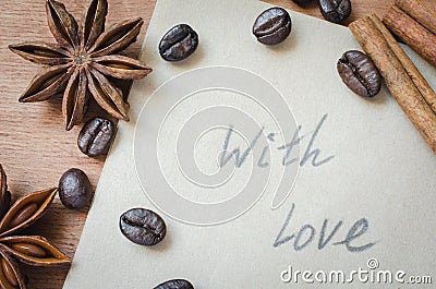 With love note and spices, sticks of cinnamon and anise star on wooden background. Stock Photo