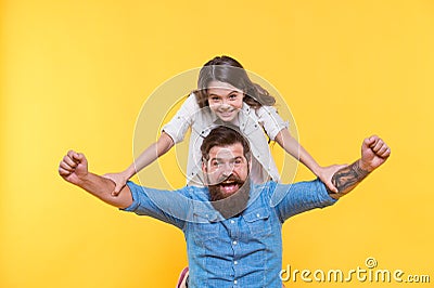 Love in our family grows deep. Happy family celebrate yellow background. Father and little daughter winth winning Stock Photo