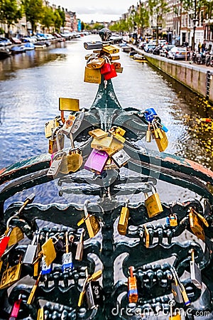 Love Padlocks on a railing of a bridge over the Keizersgracht in the old city center of Amsterdam Editorial Stock Photo