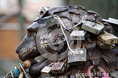 Love padlocks at rusty statue of bronze lion Editorial Stock Photo