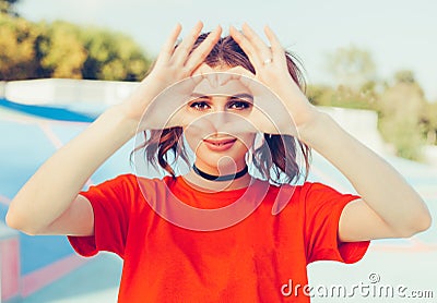 Love. Portrait smiling happy young redhead woman, making heart sign, symbol with hands. Positive human emotion expression feeling Stock Photo