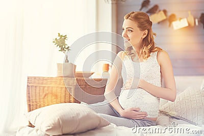 Positive pregnant woman touching her belly Stock Photo