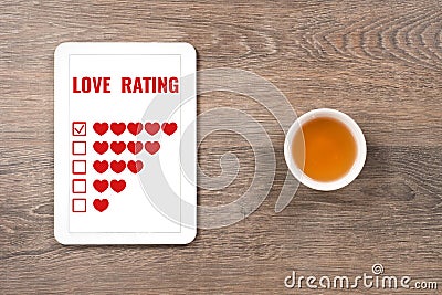 Love rating five hearts in digital tablet Stock Photo