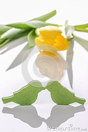 Love and romance. Happy Valentine`s Day. Two birds and yellow tulip on a light background Stock Photo