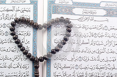 Love shape Tasbih (beads) on Holy Quran Stock Photo