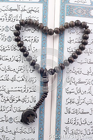 Love shape Tasbih (beads) on Holy Quran Stock Photo