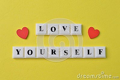 Love shapes and square letters with text LOVE YOURSELF Stock Photo