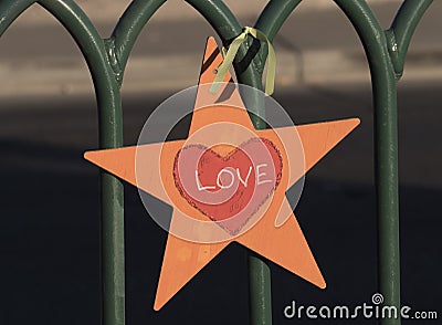 Love Star attached to a fence Stock Photo