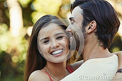 Love starts at home. Portrait of an affectionate young couple sharing a kiss outside. Stock Photo