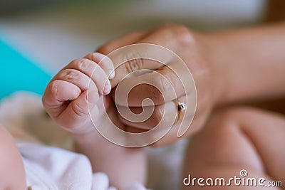 Love starts from little. mother holding her newborn babys hand. Stock Photo