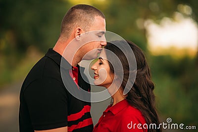 A love story in a fairy forest with a guy and a girl. He kisses her forehaed Stock Photo