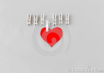 Love symbol, heart with a white clothespin and other clothespins on a turquoise background Stock Photo